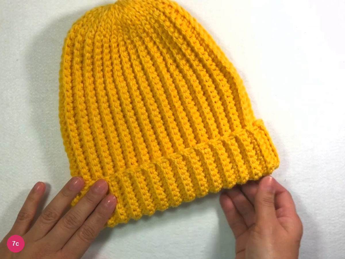 Yellow ribbed beanie with its lower edge folded up into a ribbed cuff