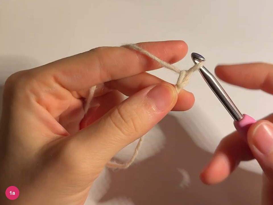 Cream starting chain held below a silver hook with a pink handle