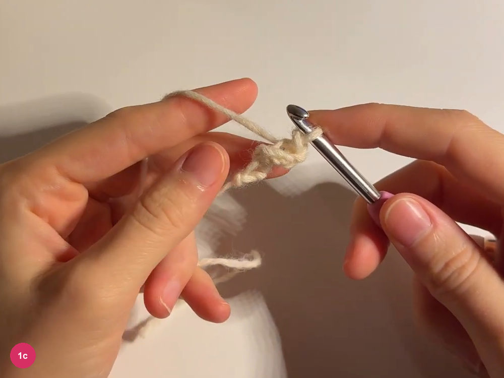 Tiny cream slip-stitch tip held beneath the hook