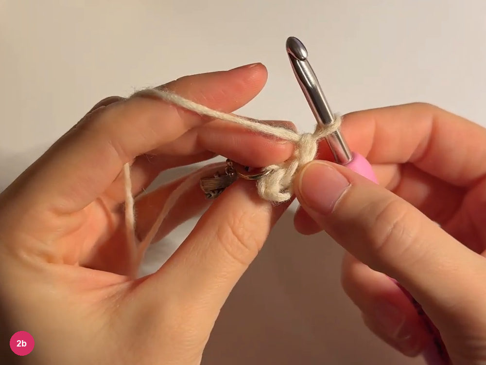 Small cream strip and turning loop held between the hands