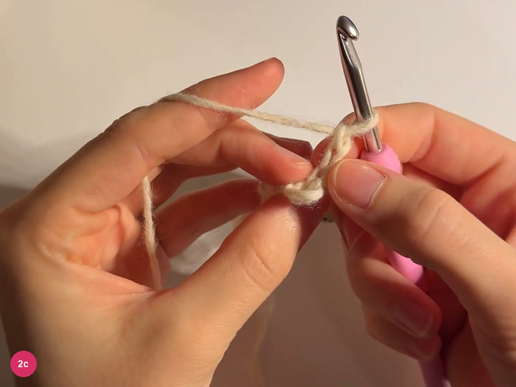 Widening cream tip with several stitch tops below the hook