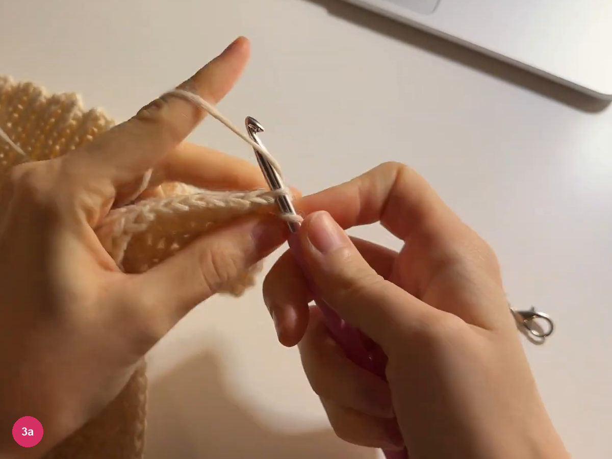 Working loop at the edge of the broad cream ribbed panel