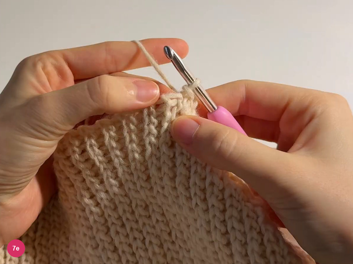 Cream back edge held upright beneath the working hook