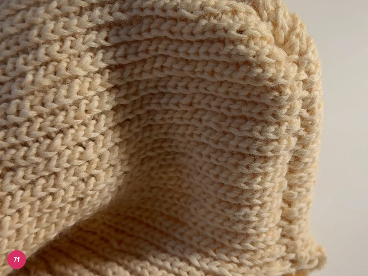 Outside of the joined cream hood with the back seam and opening visible