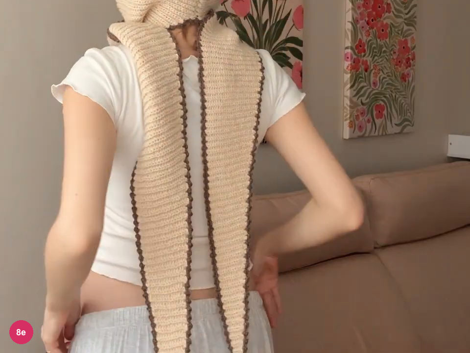 Finished brown scalloped borders along the long cream crochet bonnet ties, seen from the back