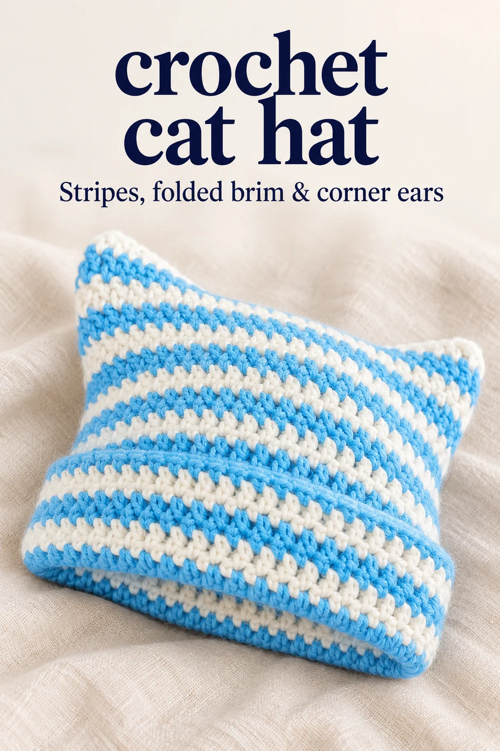Blue-and-white crochet cat hat with striped folded brim and corner ears
