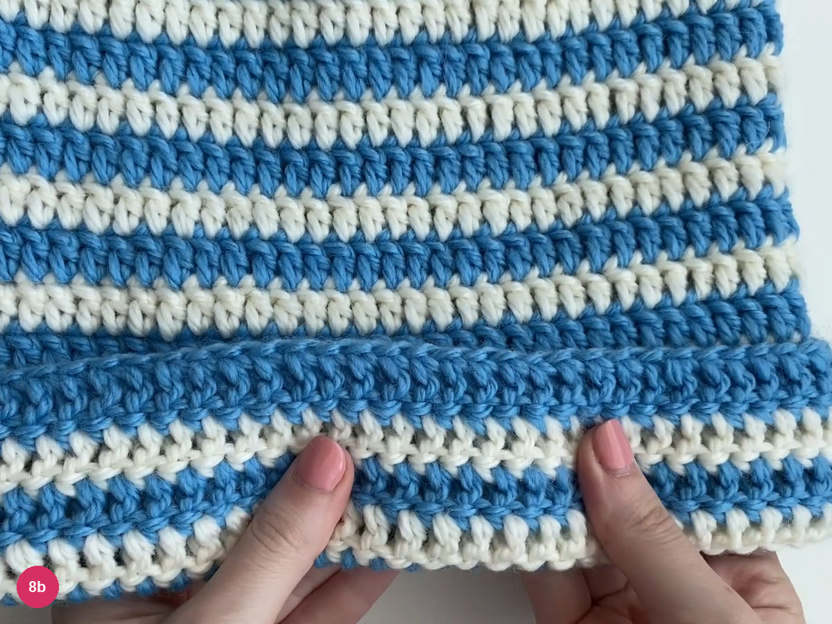 Lower blue-and-white edge folded upward into a striped brim