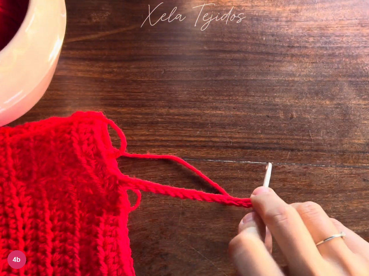 Red cuff chain extended from the body toward the purple-handled hook