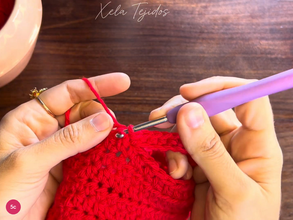 Purple-handled hook making the next attachment at the tube edge