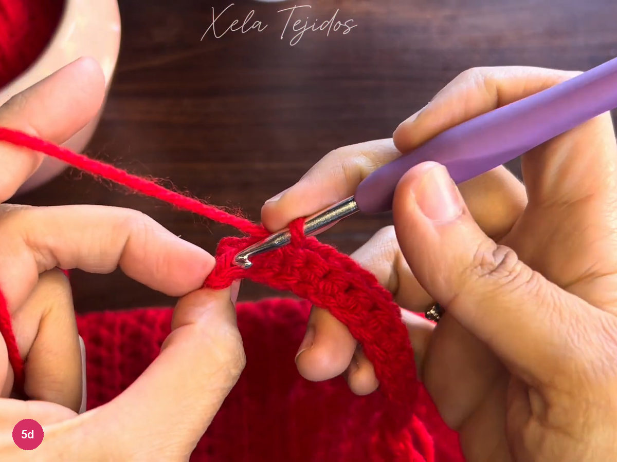 Hook at the back loop of a red cuff stitch on the narrow strip