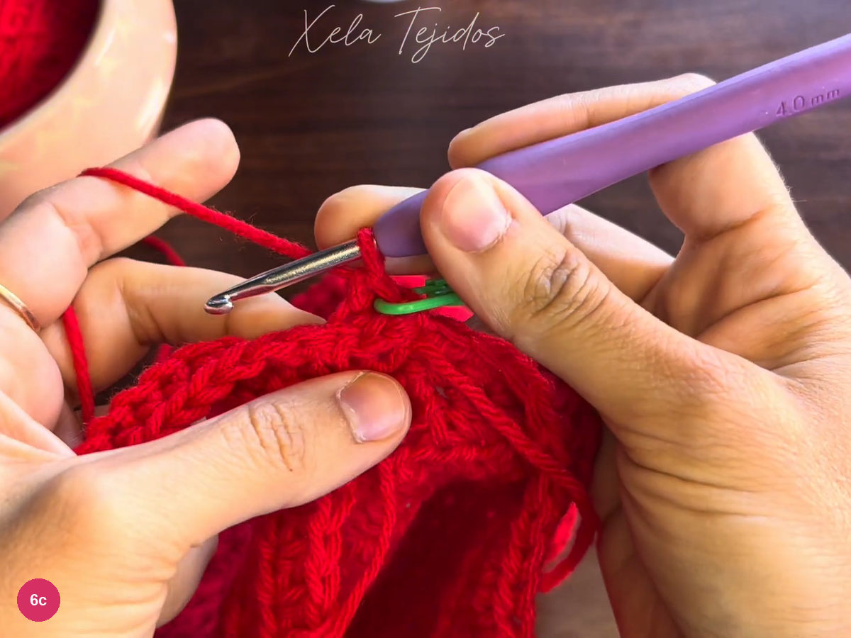 A growing section of red ribbing with green markers at its working edges