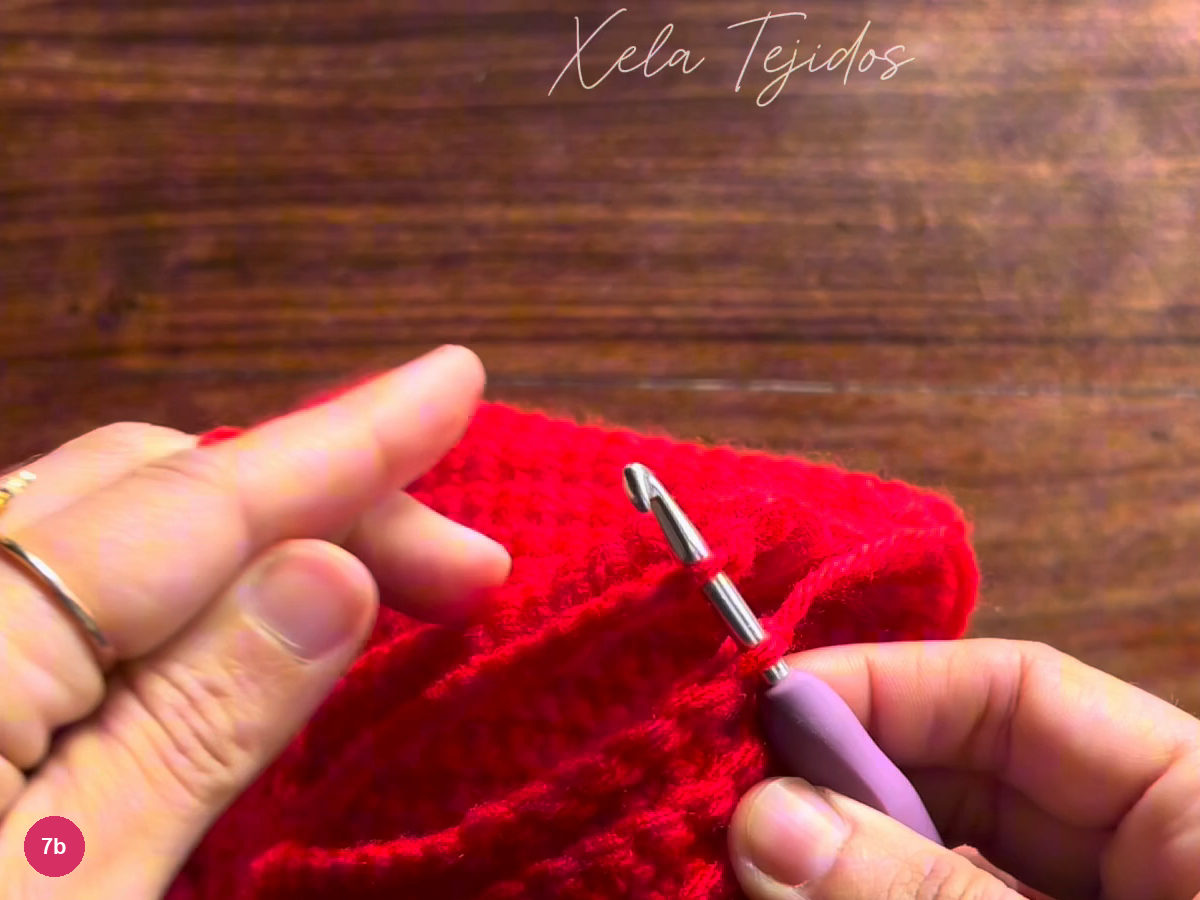 Hook through the aligned red loops of the two cuff ends