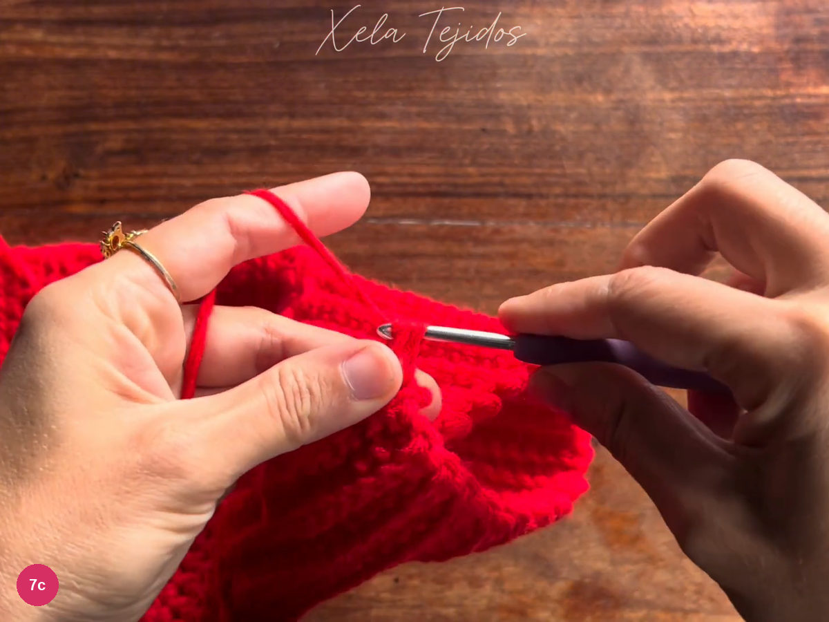 Hook joining the paired red cuff edges with single crochet
