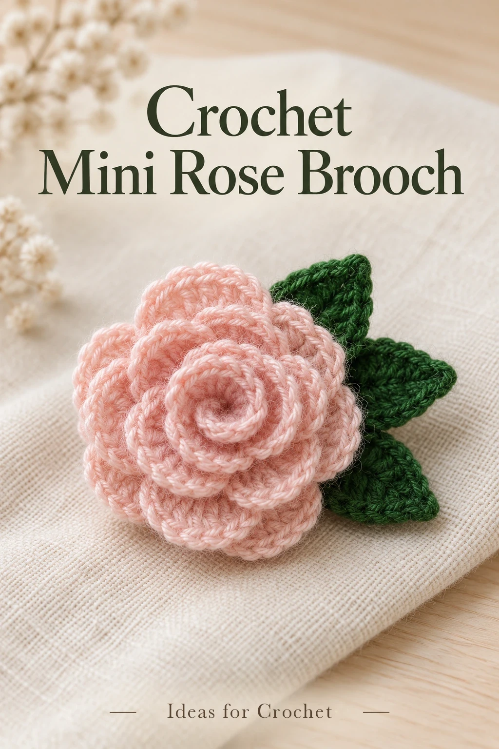 Pale pink rolled crochet rose with three green leaves