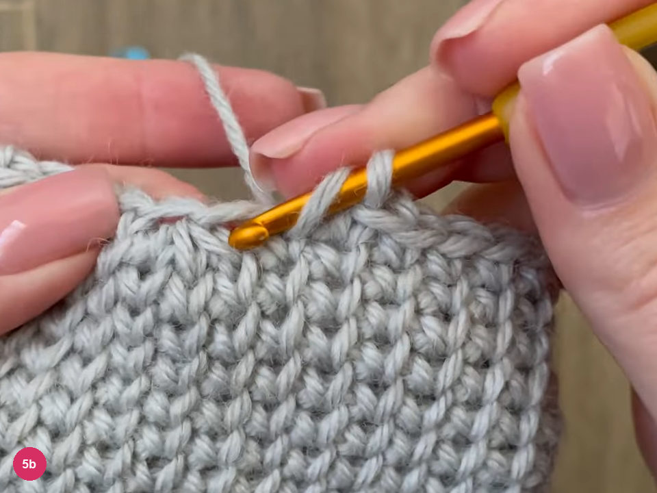 Hook with three loops pulled together at the top edge of the mitten