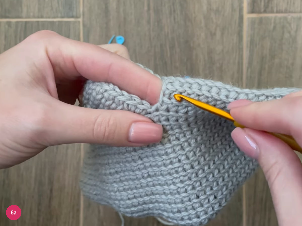 Hook at the corner of the thumb opening in the side of the mitten