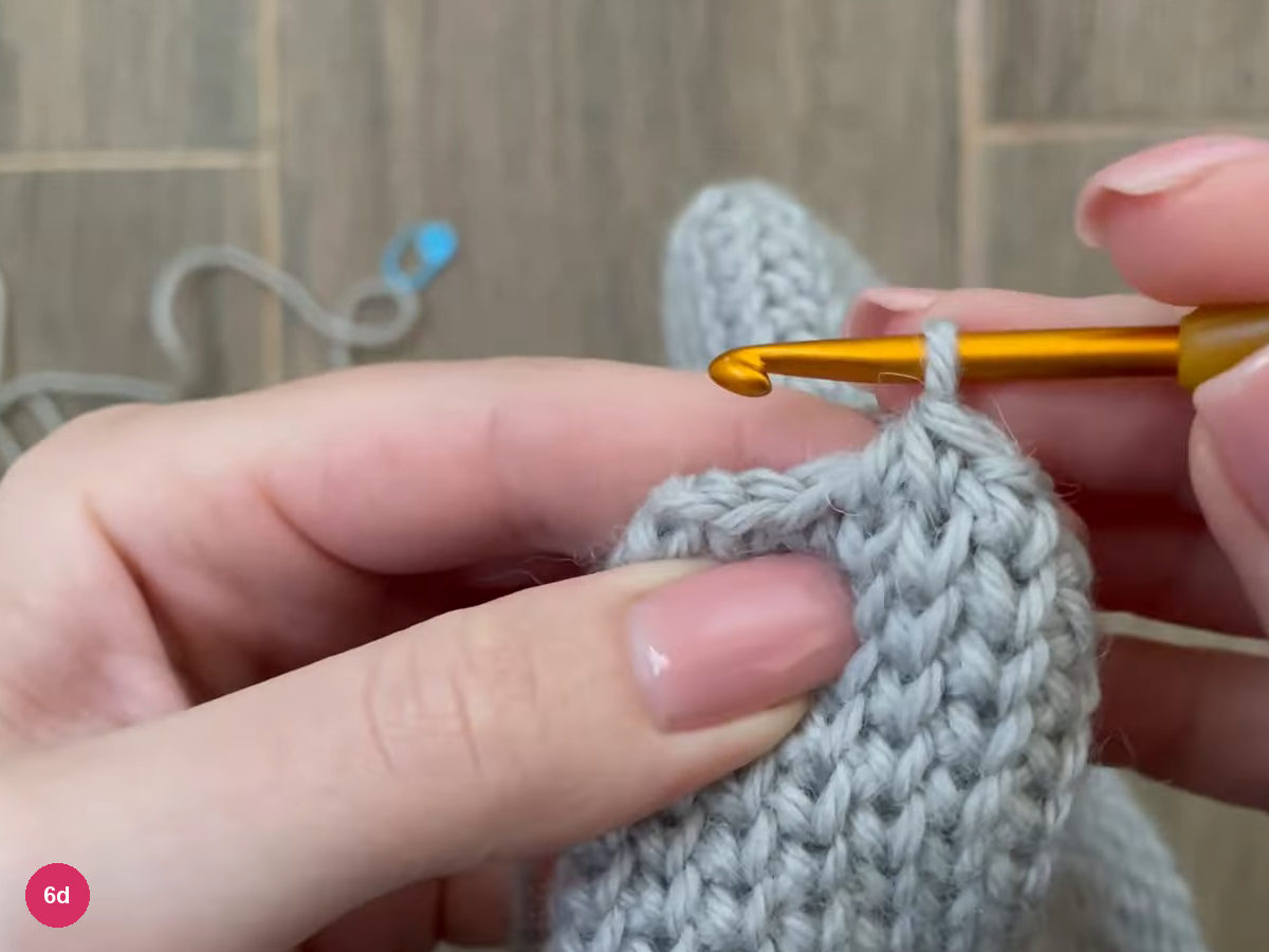 Hook with a loop at the top of the thumb tube above rounded single crochet stitches