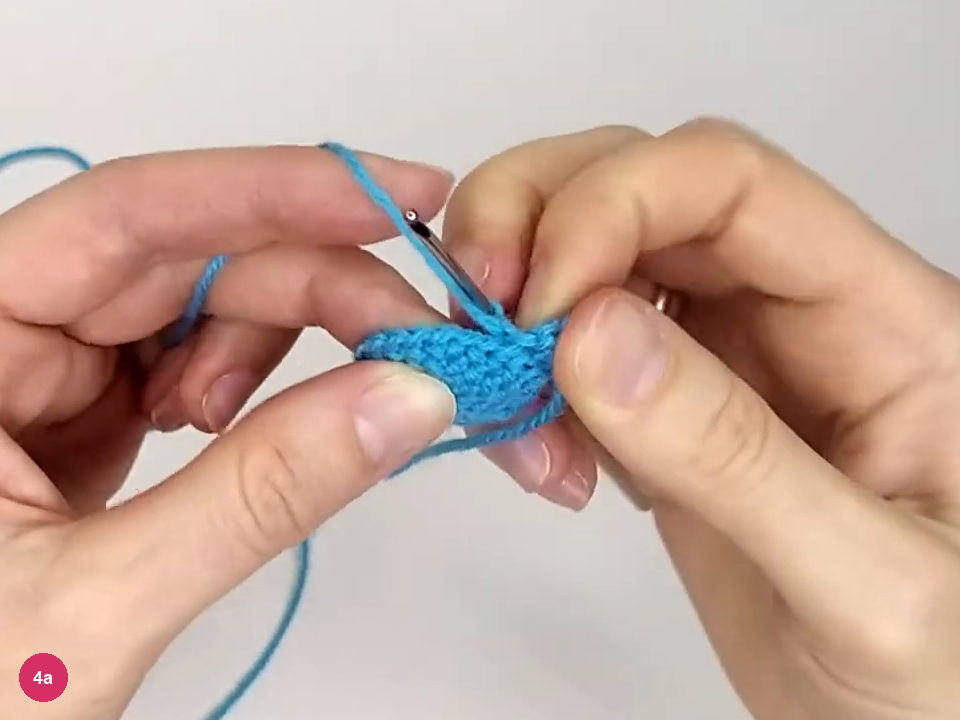 Tail attached to the turquoise body by a line of stitches