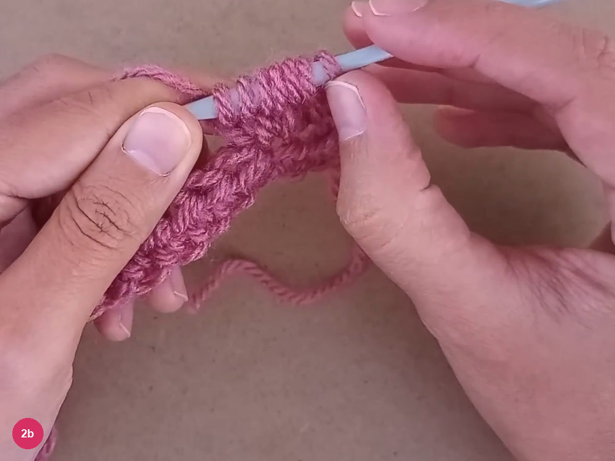 Seven gathered rose loops on the pale hook above the bobble base
