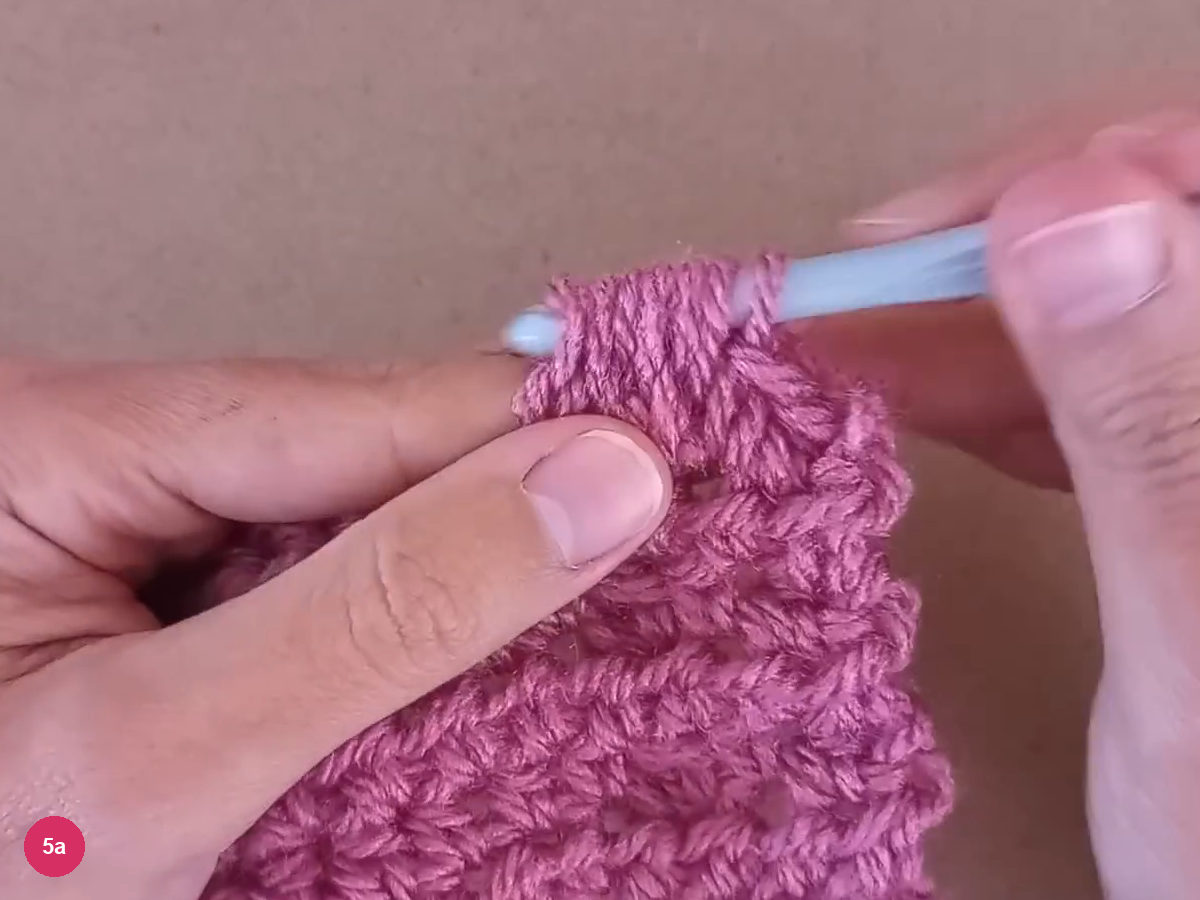 Bobble and adjacent small stitches beside the hook on the return row