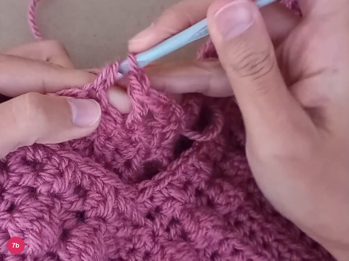 Alternating tall stitches and chain spaces forming an open neckline border