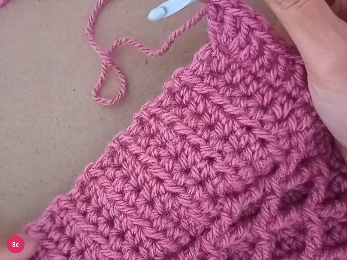 Three tall stitches opening into a small fan at the poncho point