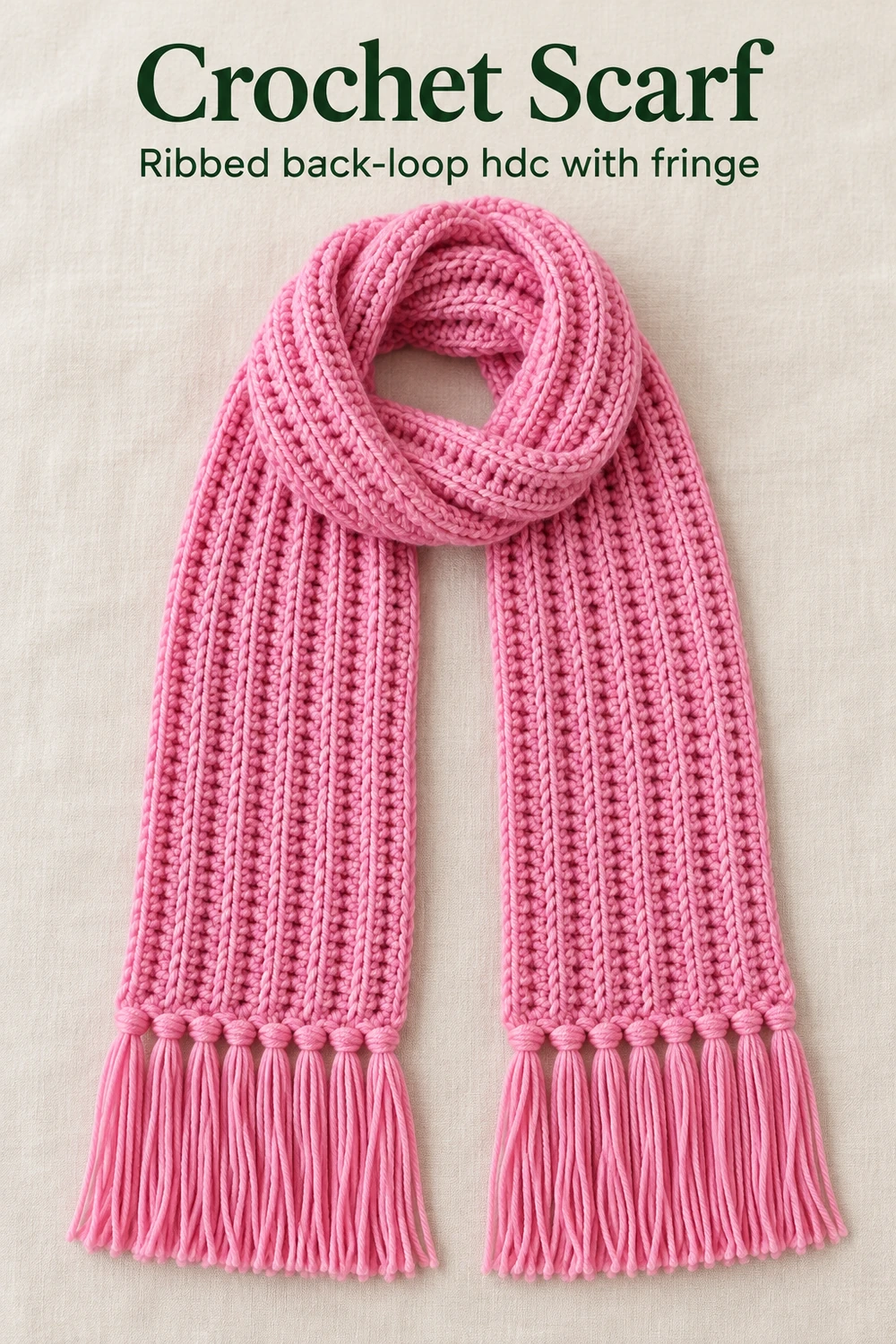 Crochet scarf in pink ribbed half double crochet with hand-knotted fringe