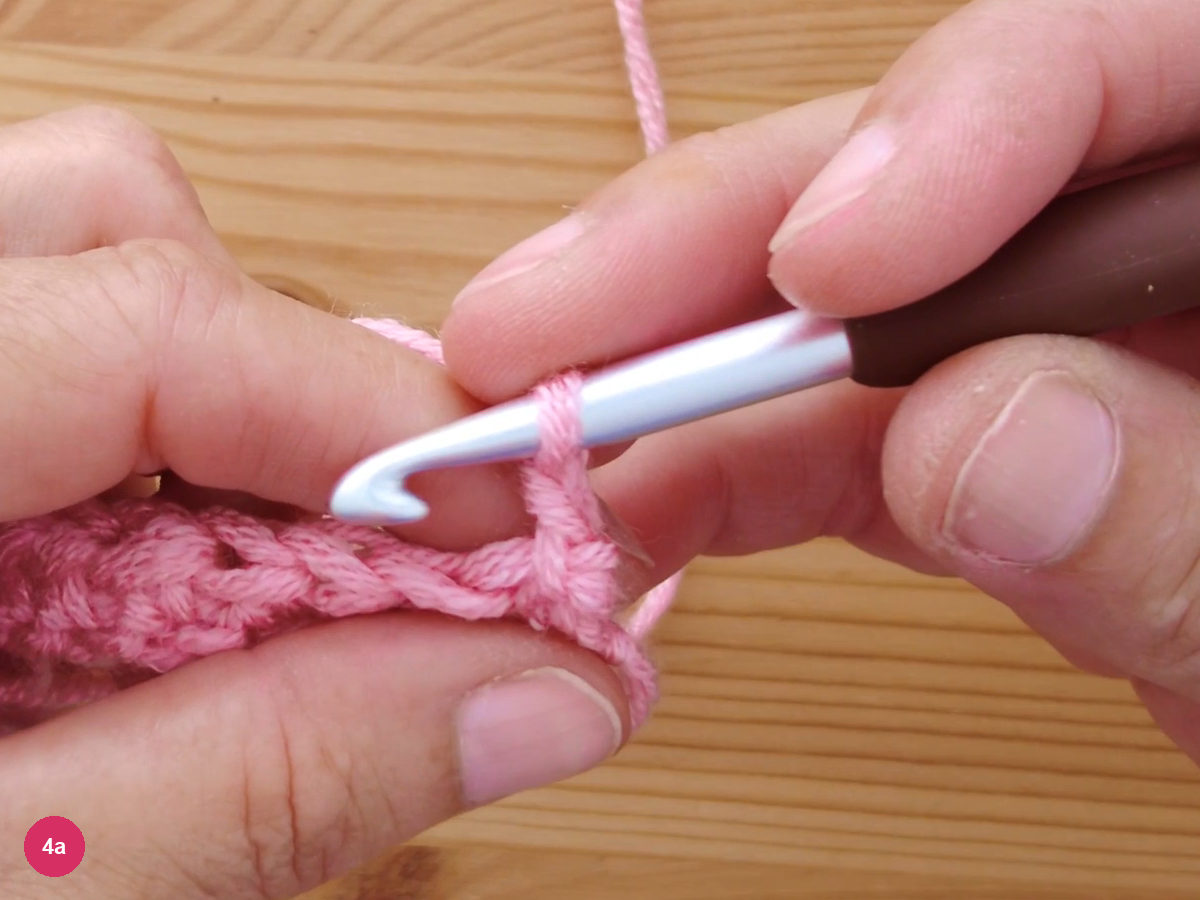 The hook at the start of a new row after turning, with the working yarn rising from the edge stitch
