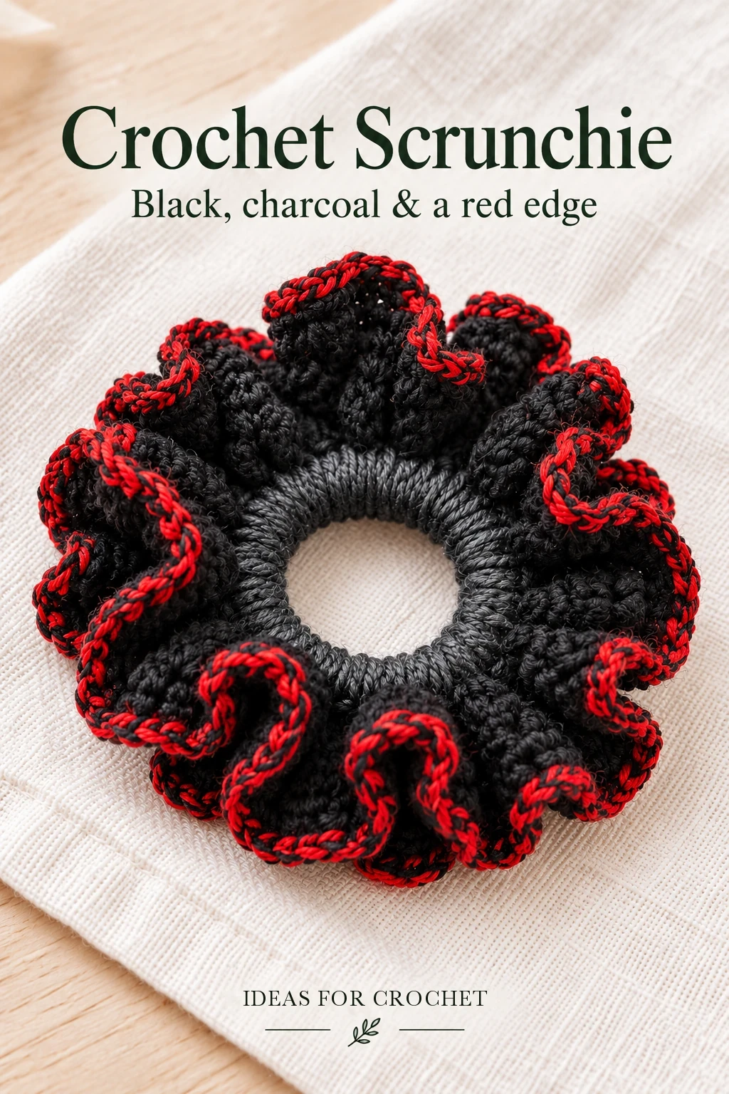 Black and charcoal crochet scrunchie with red marled trim and a project headline