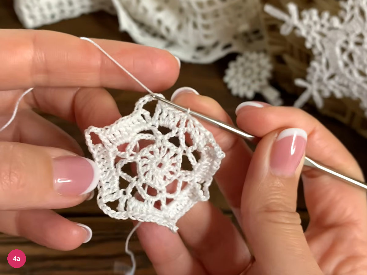 The lace framework has open corner spaces separated by bands of double crochet stitches