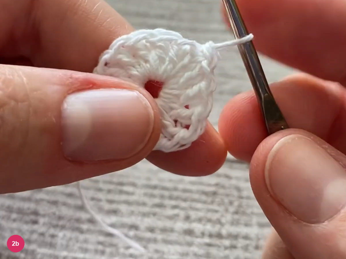 Joined white double crochet disk with the hook at its upper edge