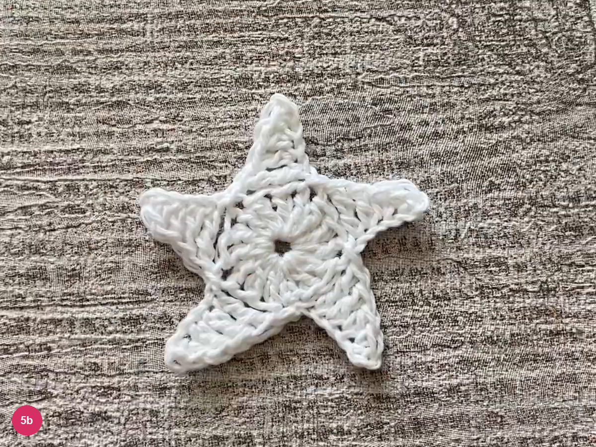 Finished flat five-point white star resting on grey wood