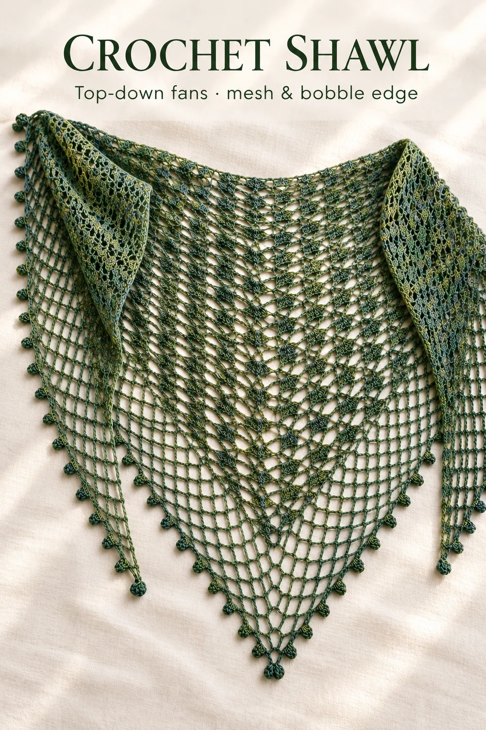 Crochet shawl with open fan lace, a mesh border and a crocheted bobble edge