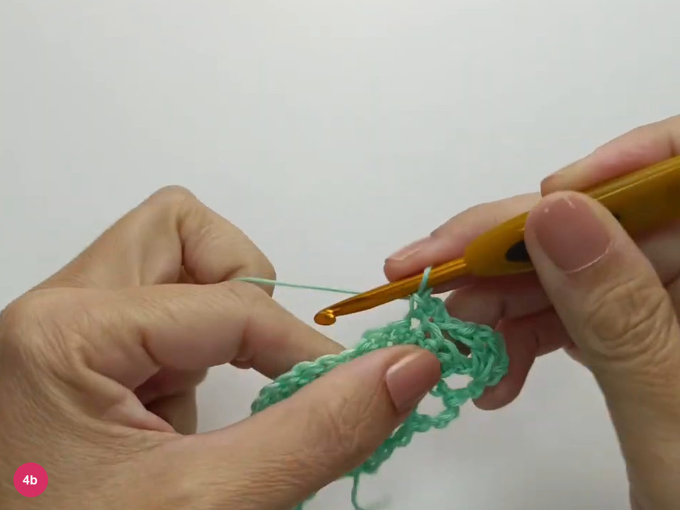 A single crochet anchors the bridge at the side fan’s center.